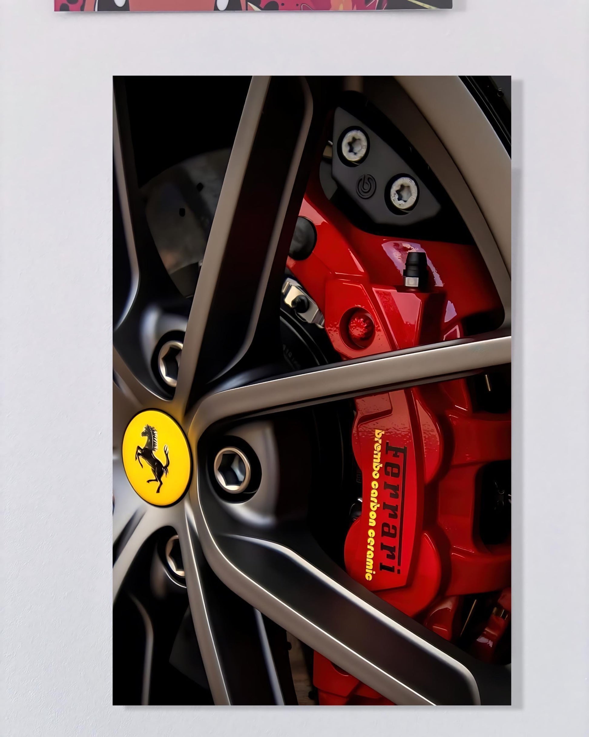 a close-up view of a Ferrari wheel, highlighting the wheel's intricate design and the red brake calipers.