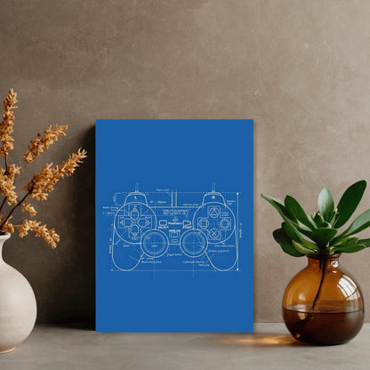 a blue poster with a technical drawing of a joystick, placed on a wall next to a vase with flowers and a potted plant.