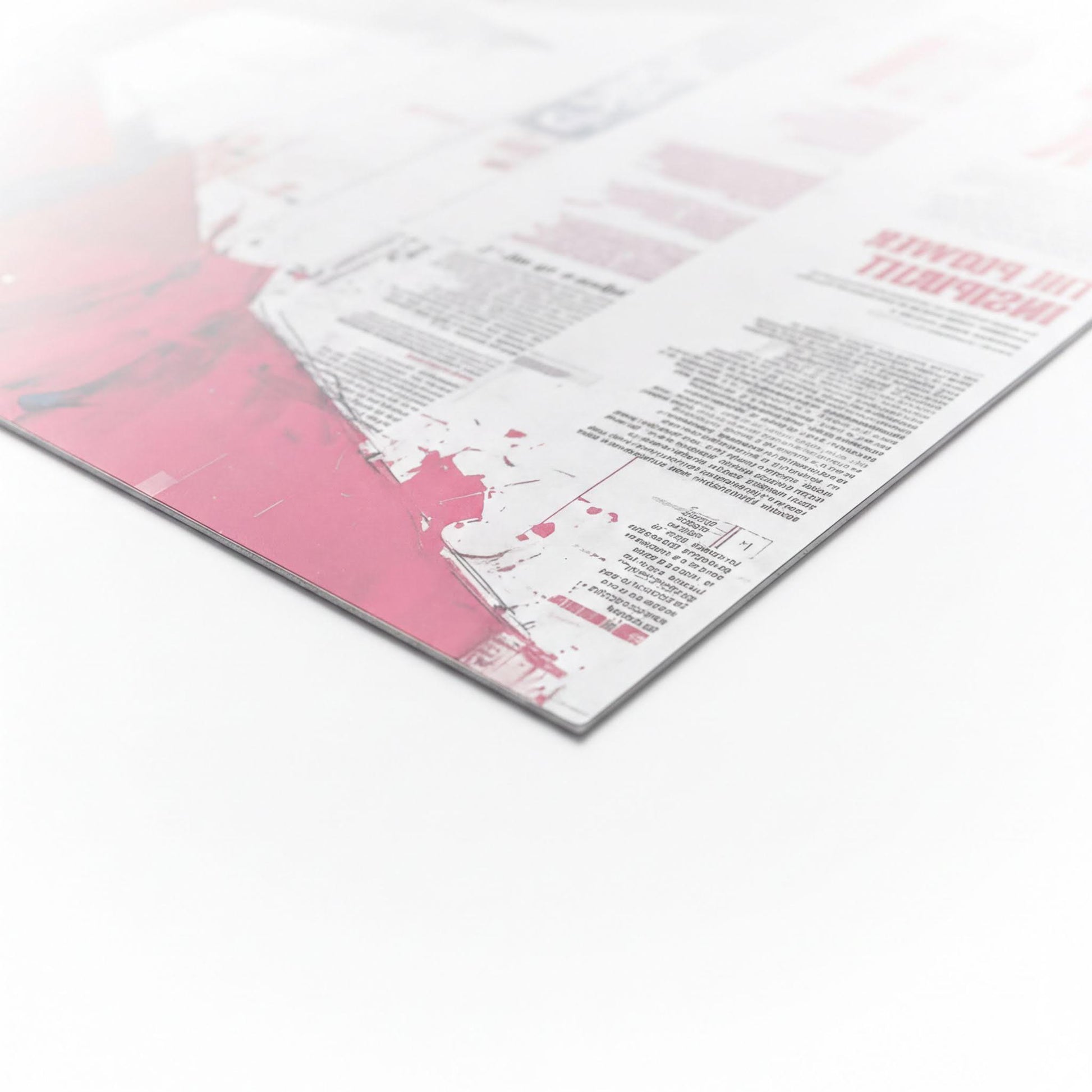 The image is a close-up of a printed document or flyer with a pink and white color scheme. The document appears to be a mix of text and graphics, but the specific content is not clearly visible. The image does not contain any identifiable objects or actions, and there are no clear actions or movements depicted. The document does not contain any text that can be transcribed, and the image does not contain any identifiable objects or actions.